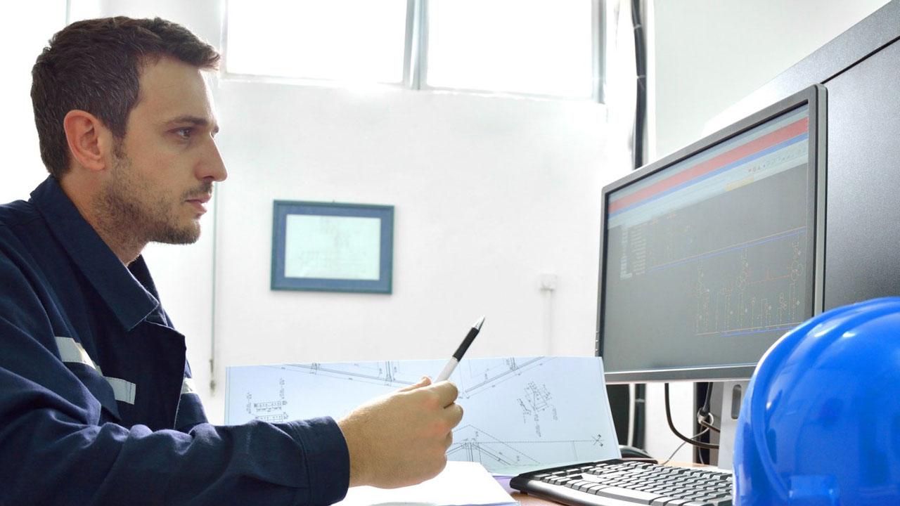 Compliance specialist reviewing landfill air permitting data on a computer screen