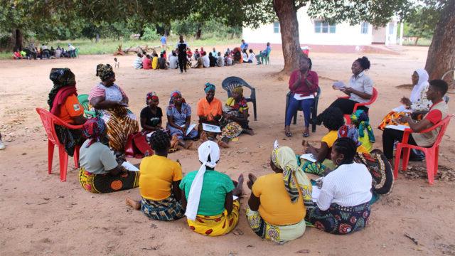 A group of women sit in a circle for a training in Nampula, Mozambique